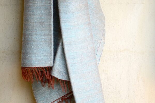 Pale blue throw woven on rust warp