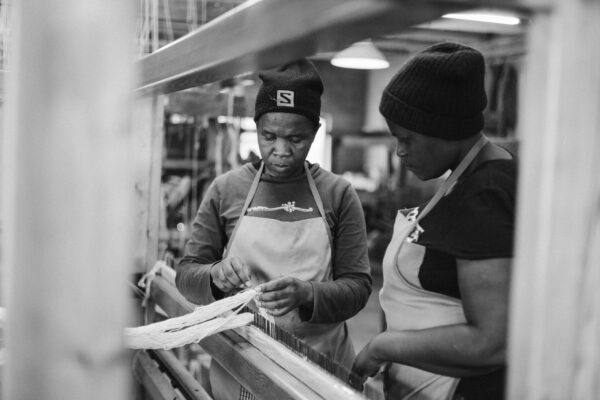 Phindele and Kayise putting a warp on a loom